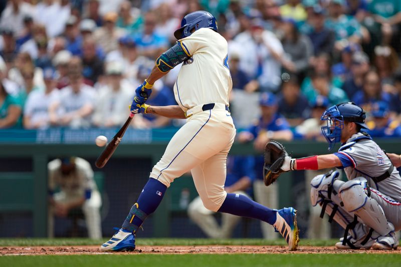 Aug 3, 2025; Seattle, Washington, USA; Seattle Mariners center fielder Julio Rodríguez (44) hits a two RBI home run off Texas Rangers starting pitcher Jacob deGrom (48) during the third inning at T-Mobile Park. Mandatory Credit: John Froschauer-Imagn Images