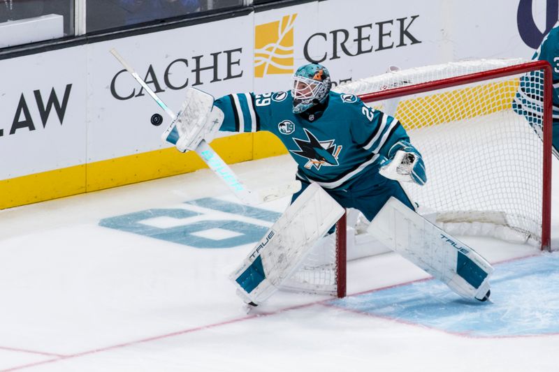 Nov 23, 2024; San Jose, California, USA; San Jose Sharks goaltender Mackenzie Blackwood (29) deflects a shot by a Buffalo Sabres player during the third period at SAP Center in San Jose. Mandatory Credit: John Hefti-Imagn Images