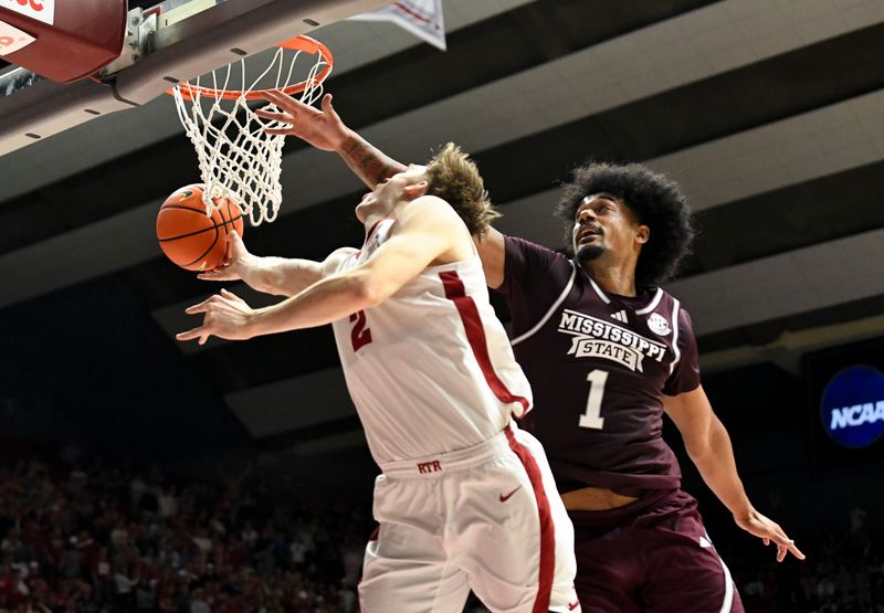 Feb 3, 2024; Tuscaloosa, Alabama, USA;  Alabama forward Grant Nelson (2) tries to loop a shot under the basket as he is defended by Mississippi State forward Tolu Smith III (1) at Coleman Coliseum. Mandatory Credit: Gary Cosby Jr.-USA TODAY Sports