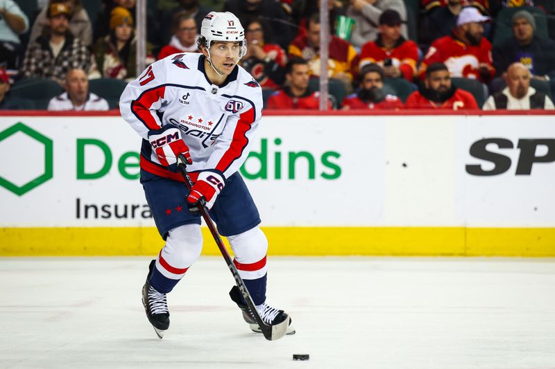 Jan 28, 2025; Calgary, Alberta, CAN; Washington Capitals center Dylan Strome (17) skates with the puck against the Calgary Flames during the second period at Scotiabank Saddledome. Mandatory Credit: Sergei Belski-Imagn Images