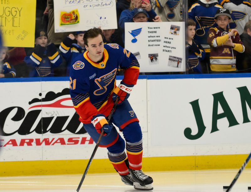 Apr 1, 2025; St. Louis, Missouri, USA; St. Louis Blues right wing Jimmy Snuggerud (21) warms up before his NHL debut against the Detroit Red Wings at Enterprise Center. Mandatory Credit: Jeff Le-Imagn Images