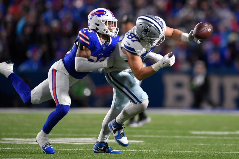 Buffalo Bills cornerback Cam Lewis, left, breaks up a pass intended for Dallas Cowboys tight end Jake Ferguson during the first half of an NFL football game in Orchard Park, N.Y., Sunday, Dec. 17, 2023. (AP Photo/Adrian Kraus)