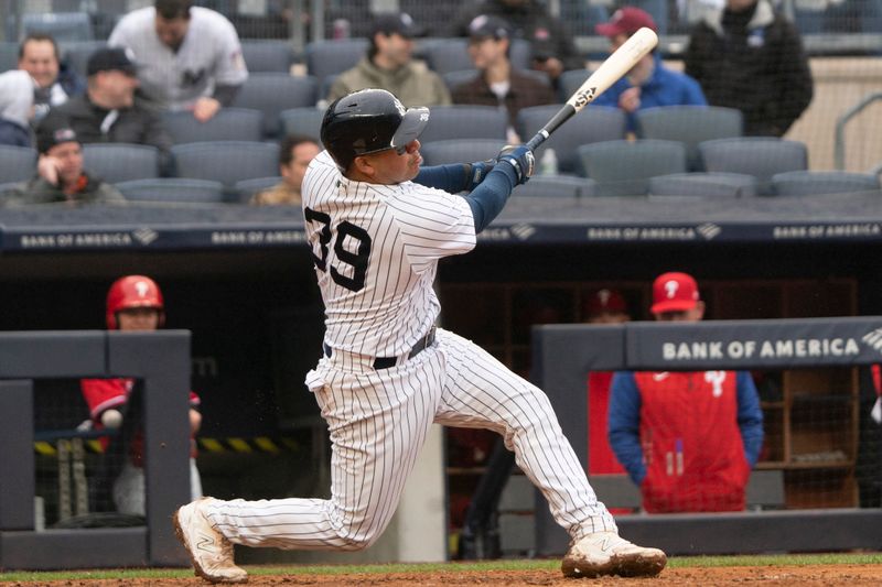 Apr 5, 2023; Bronx, New York, USA;  New York Yankees catcher Jose Trevino (39) hits a two run home run against the Philadelphia Phillies during the seventh inning at Yankee Stadium. Mandatory Credit: Gregory Fisher-USA TODAY Sports