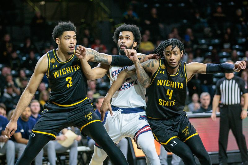 Feb 11, 2024; Wichita, Kansas, USA; Wichita State Shockers forward Ronnie DeGray III (3) and Wichita State Shockers forward Isaac Abidde (5) block out Florida Atlantic Owls guard Jalen Gaffney (12) during the second half at Charles Koch Arena. Mandatory Credit: William Purnell-USA TODAY Sports