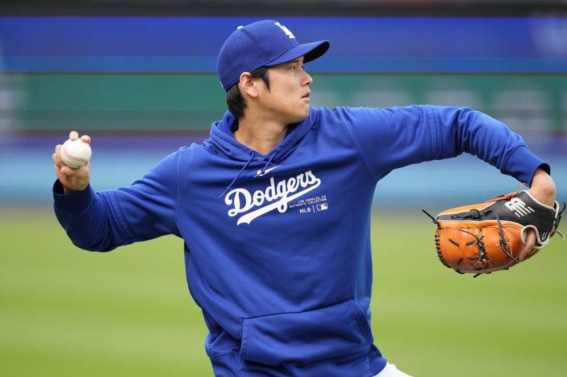 Mar 25, 2024; Los Angeles, California, USA; Los Angeles Dodgers designated hitter Shohei Ohtani throws before the game against the Los Angeles Angels at Dodger Stadium. Mandatory Credit: Kirby Lee-USA TODAY Sports