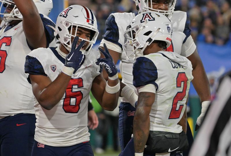 Nov 12, 2022; Pasadena, California, USA;  Arizona Wildcats running back Michael Wiley (6) celebrates with wide receiver Jacob Cowing (2) after his second touchdown in the first half against the UCLA Bruins at the Rose Bowl. Mandatory Credit: Jayne Kamin-Oncea-USA TODAY Sports