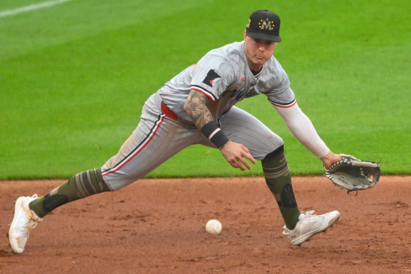 May 17, 2024; Cleveland, Ohio, USA; Minnesota Twins third baseman Jose Miranda (64) reaches for the ball on a base hit in the third inning against the Cleveland Guardians at Progressive Field. Mandatory Credit: David Richard-USA TODAY Sports