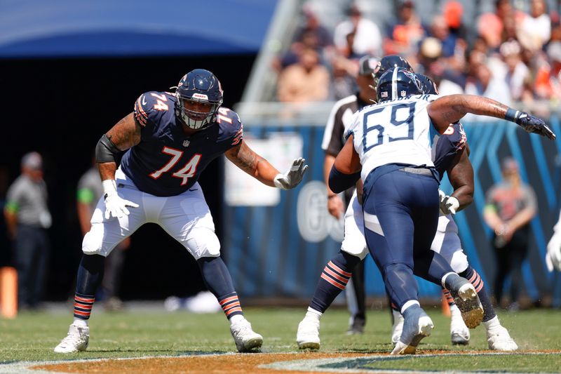 Chicago Bears offensive tackle Aviante Collins (74) blocks against the Tennessee Titans during the first half of an NFL preseason football game, Saturday, Aug. 12, 2023, in Chicago. (AP Photo/Kamil Krzaczynski)