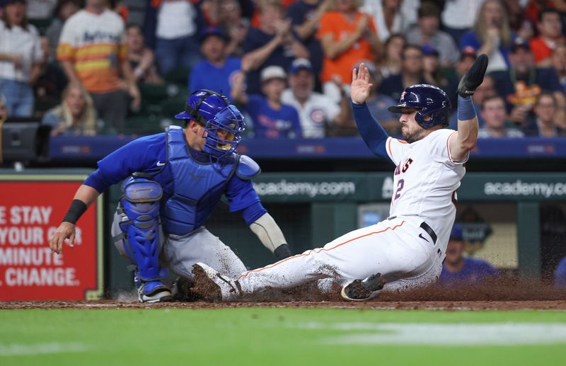 May 17, 2023; Houston, Texas, USA; Houston Astros third baseman Alex Bregman (2) is tagged out by Chicago Cubs catcher Yan Gomes (15) on a play at the plate during the sixth inning at Minute Maid Park. Mandatory Credit: Troy Taormina-USA TODAY Sports