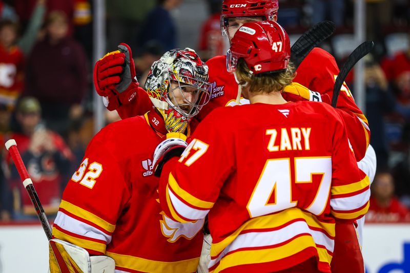 Oct 26, 2025; Calgary, Alberta, CAN; Calgary Flames goaltender Dustin Wolf (32) celebrates win with teammates after defeating New York Rangers at Scotiabank Saddledome. Mandatory Credit: Sergei Belski-Imagn Images