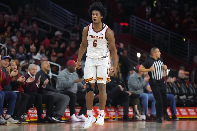 Jan 14, 2025; Los Angeles, California, USA; Southern California Trojans guard Wesley Yates III (6) celebrates after a three-point shot against the Iowa Hawkeyes in the first half at Galen Center. Mandatory Credit: Kirby Lee-Imagn Images