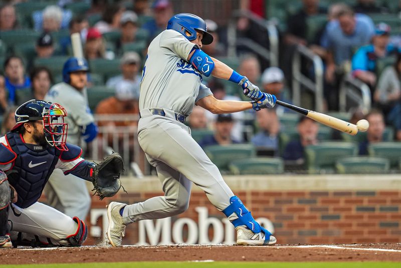 Sep 15, 2024; Cumberland, Georgia, USA; Los Angeles Dodgers shortstop Tommy Edman (25) hits a double against the Atlanta Braves during the second inning at Truist Park. Mandatory Credit: Dale Zanine-Imagn Images