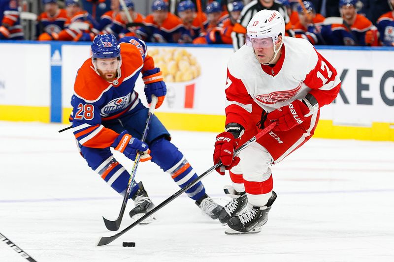 Feb 13, 2024; Edmonton, Alberta, CAN; Detroit Red Wings defensemen Filip Hronek (17) moved the puck in front of Edmonton Oilers forward Connor Brown (28) during the second period at Rogers Place. Mandatory Credit: Perry Nelson-USA TODAY Sports