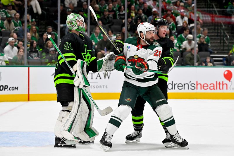 Jan 10, 2024; Dallas, Texas, USA; Minnesota Wild left wing Pat Maroon (20) and Dallas Stars defenseman Ryan Suter (20) look for the puck in front of goaltender Scott Wedgewood (41) during the first period at the American Airlines Center. Mandatory Credit: Jerome Miron-USA TODAY Sports