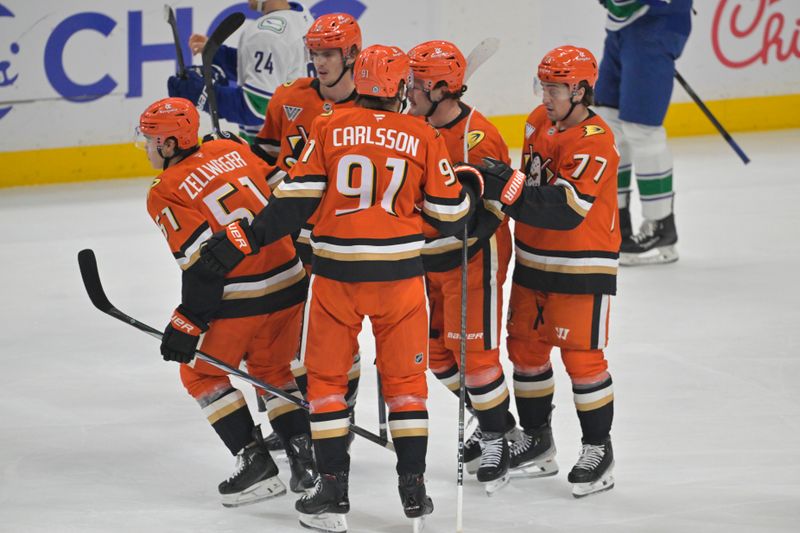 Nov 5, 2024; Anaheim, California, USA; Anaheim Ducks defenseman Olen Zellweger (51) is congratulated after scoring a goal in the first period against the Vancouver Canucks at Honda Center. Mandatory Credit: Jayne Kamin-Oncea-Imagn Images