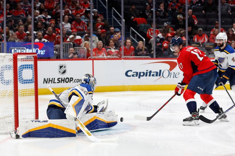 Jan 18, 2024; Washington, District of Columbia, USA; Washington Capitals center Dylan Strome (17) scores a goal on St. Louis Blues goaltender Jordan Binnington (50) in the third period at Capital One Arena. Mandatory Credit: Geoff Burke-USA TODAY Sports