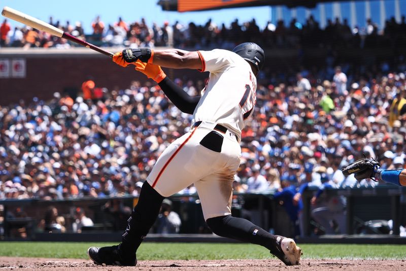 Jun 30, 2024; San Francisco, California, USA; San Francisco Giants center fielder Heliot Ramos (17) hits an RBI double against the Los Angeles Dodgers during the fourth inning at Oracle Park. Mandatory Credit: Kelley L Cox-USA TODAY Sports