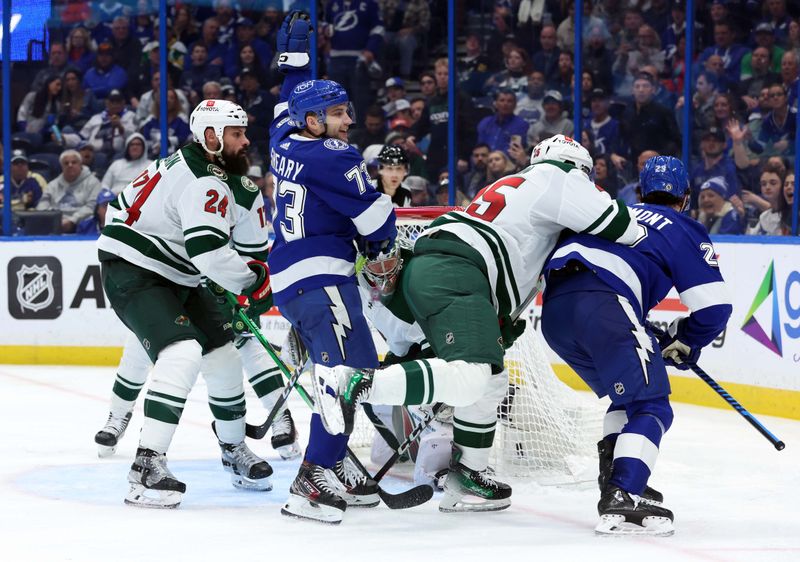 Jan 18, 2024; Tampa, Florida, USA; Tampa Bay Lightning center Michael Eyssimont (23) scores on Minnesota Wild goaltender Filip Gustavsson (32) as Lightning left wing Conor Sheary (73) celebrates during the third period at Amalie Arena. Mandatory Credit: Kim Klement Neitzel-USA TODAY Sports