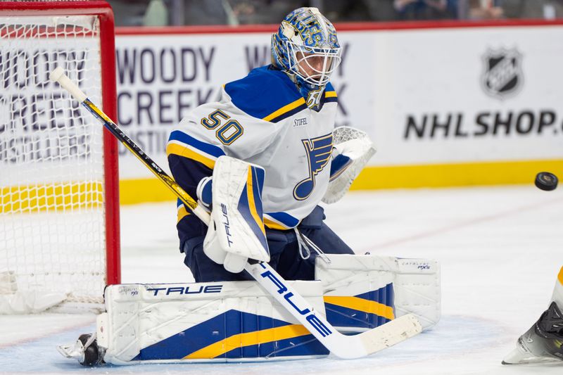 Jan 7, 2025; Saint Paul, Minnesota, USA; St. Louis Blues goaltender Jordan Binnington (50) makes a save against the Minnesota Wild in the second period at Xcel Energy Center. Mandatory Credit: Matt Blewett-Imagn Images