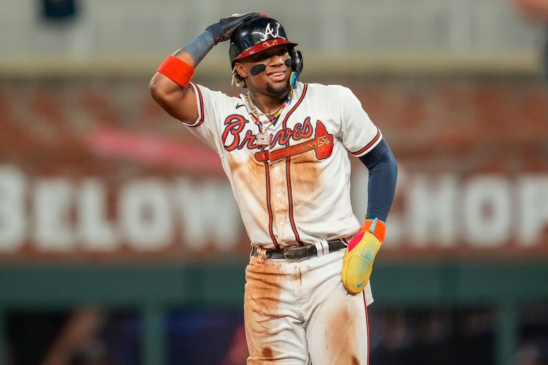 Sep 27, 2023; Cumberland, Georgia, USA; Atlanta Braves right fielder Ronald Acuna Jr. (13) reacts after stealing his 70th base of the season against the Chicago Cubs during the tenth inning at Truist Park. Mandatory Credit: Dale Zanine-USA TODAY Sports