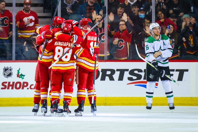 Nov 30, 2023; Calgary, Alberta, CAN; Calgary Flames defenseman Chris Tanev (8) celebrates his goal with teammates against the Dallas Stars during the first period at Scotiabank Saddledome. Mandatory Credit: Sergei Belski-USA TODAY Sports