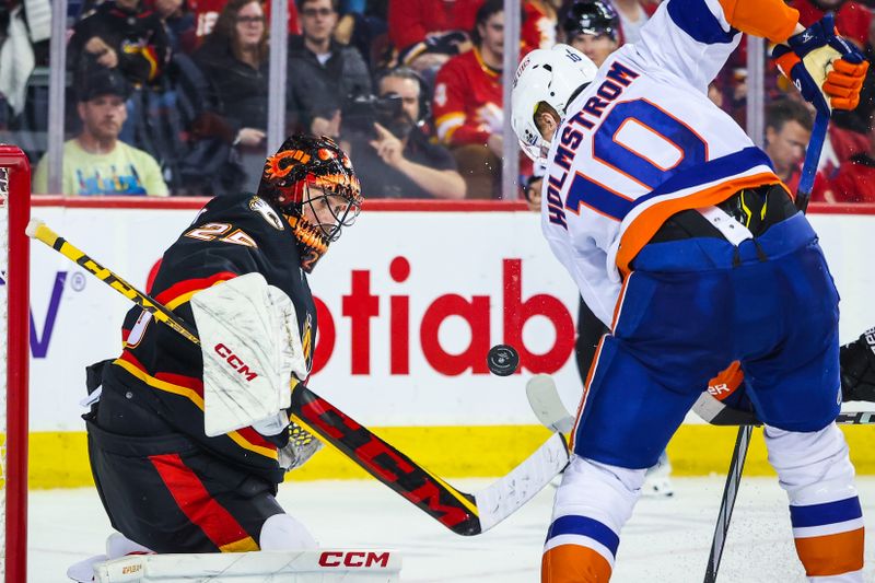 Nov 18, 2023; Calgary, Alberta, CAN; Calgary Flames goaltender Jacob Markstrom (25) makes a save against New York Islanders right wing Simon Holmstrom (10) during the third period at Scotiabank Saddledome. Mandatory Credit: Sergei Belski-USA TODAY Sports