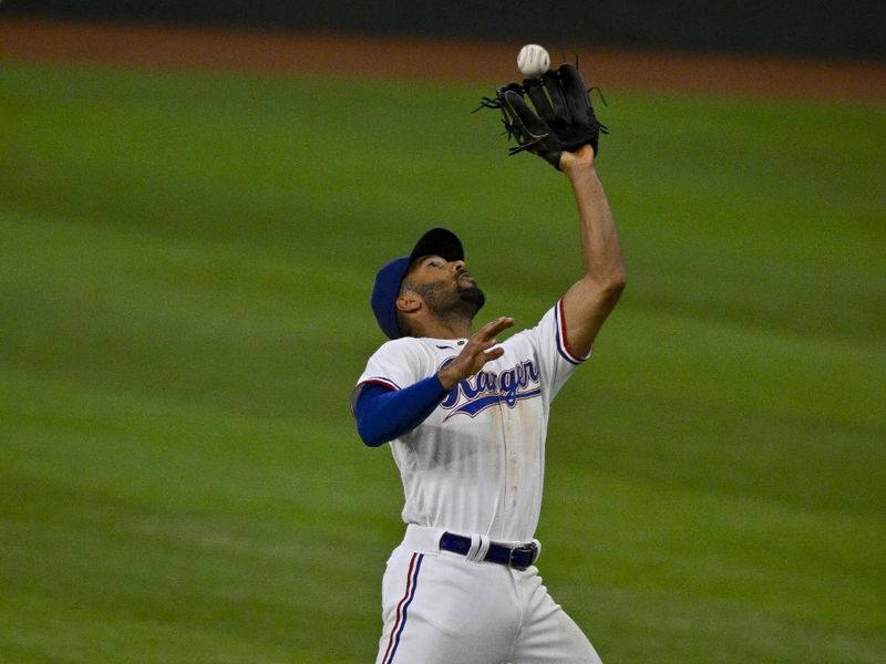 Aug 3, 2023; Arlington, Texas, USA; Texas Rangers second baseman Marcus Semien (2) catches a fly ball during the eighth inning at Globe Life Field. Mandatory Credit: Jerome Miron-USA TODAY Sports