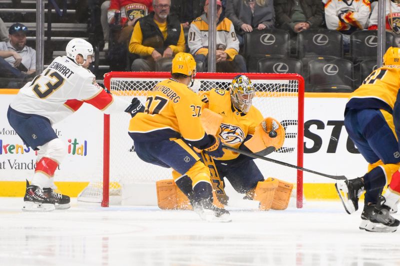 Feb 25, 2025; Nashville, Tennessee, USA;  Nashville Predators goaltender Juuse Saros (74) blocks the shot of Florida Panthers center Carter Verhaeghe (23) during the first period at Bridgestone Arena. Mandatory Credit: Steve Roberts-Imagn Images