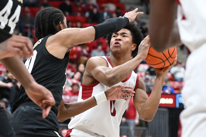 Jan 27, 2024; Pullman, Washington, USA; Washington State Cougars forward Jaylen Wells (0) shoots the ball against Washington State Cougars guard Parker Gerrits (10) in the second half at Friel Court at Beasley Coliseum. Washington State won 78-69. Mandatory Credit: James Snook-USA TODAY Sports