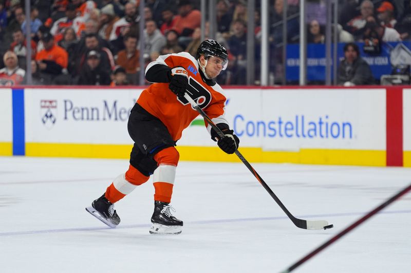 Nov 23, 2024; Philadelphia, Pennsylvania, USA; Philadelphia Flyers defenseman Emil Andrae (36) shoots the puck against the Chicago Blackhawks in the first period at Wells Fargo Center. Mandatory Credit: Kyle Ross-Imagn Images