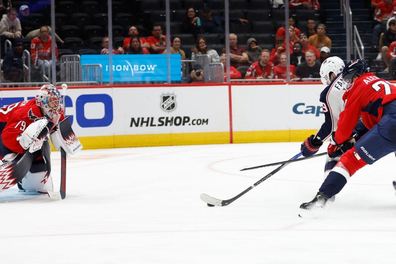 Sep 27, 2024; Washington, District of Columbia, USA; Columbus Blue Jackets center Adam Fantilli (19) scores a goal on Washington Capitals goaltender Charlie Lindgren (79) as Capitals defenseman Alexander Alexeyev (27) defends in the second period at Capital One Arena. Mandatory Credit: Geoff Burke-Imagn Images