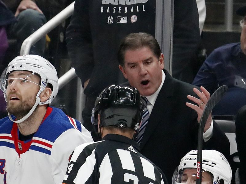 Nov 22, 2023; Pittsburgh, Pennsylvania, USA; New York Rangers head coach Peter Laviolette (rear) talks with referee Graham Skilliter (24) against the Pittsburgh Penguins during the first period at PPG Paints Arena. Mandatory Credit: Charles LeClaire-USA TODAY Sports