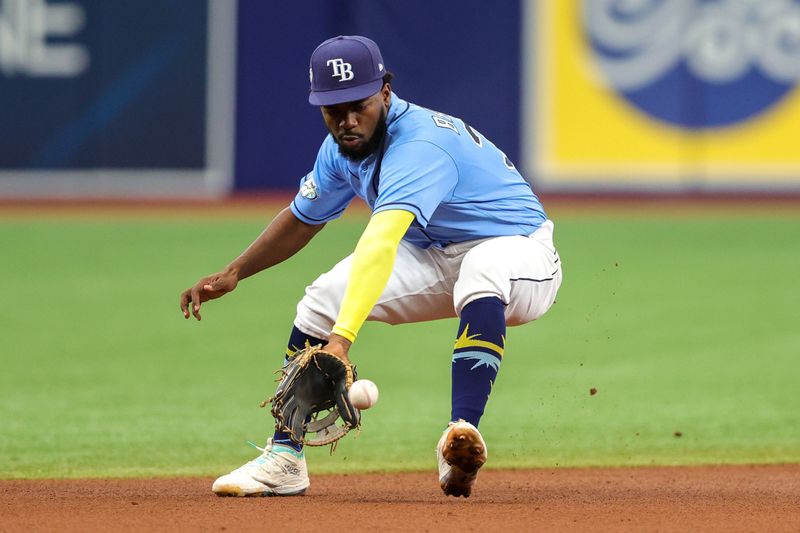 Aug 27, 2023; St. Petersburg, Florida, USA;  Tampa Bay Rays shortstop Osleivis Basabe (37) fields the ball against the New York Yankees in the fifth inning at Tropicana Field. Mandatory Credit: Nathan Ray Seebeck-USA TODAY Sports