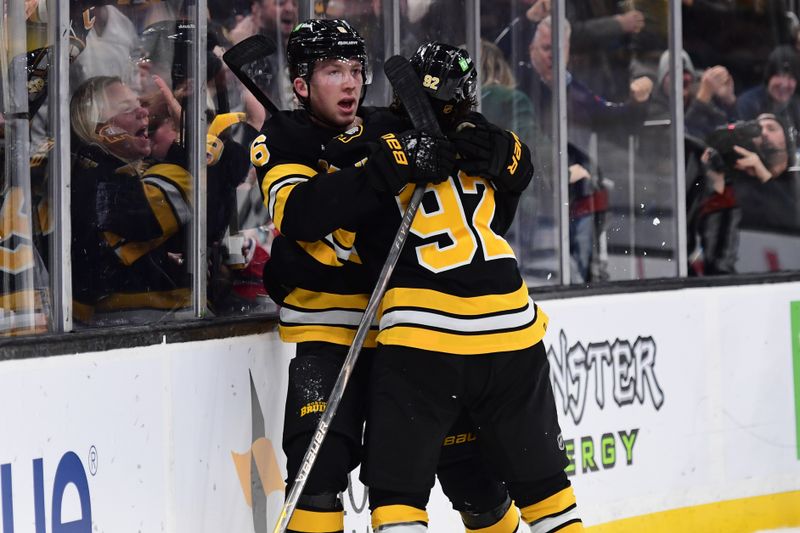 Dec 23, 2025; Boston, Massachusetts, USA; Boston Bruins defenseman Mason Lohrei (6) congratulates center Marat Khusnutdinov (92) after scoring a goal during the first period against the Montreal Canadians at TD Garden. Mandatory Credit: Bob DeChiara-Imagn Images