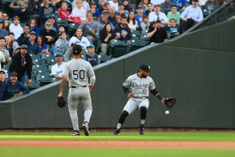 Jun 12, 2024; Seattle, Washington, USA; Chicago White Sox left fielder Corey Julks (30) misses the catch on Seattle Mariners pop fly ball during the fifth inning at T-Mobile Park. Mandatory Credit: Steven Bisig-USA TODAY Sports