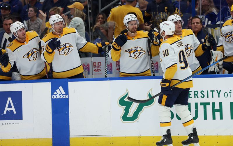 Oct 10, 2023; Tampa, Florida, USA; Nashville Predators center Ryan O'Reilly (90) is congratulated after he scored against the Tampa Bay Lightning during the second period at Amalie Arena. Mandatory Credit: Kim Klement Neitzel-USA TODAY Sports