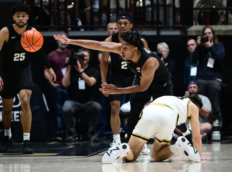 Mar 2, 2024; West Lafayette, Indiana, USA; Michigan State Spartans guard A.J. Hoggard (11) passes a loose ball away from Purdue Boilermakers forward Camden Heide (23) during the first half at Mackey Arena. Mandatory Credit: Marc Lebryk-USA TODAY Sports