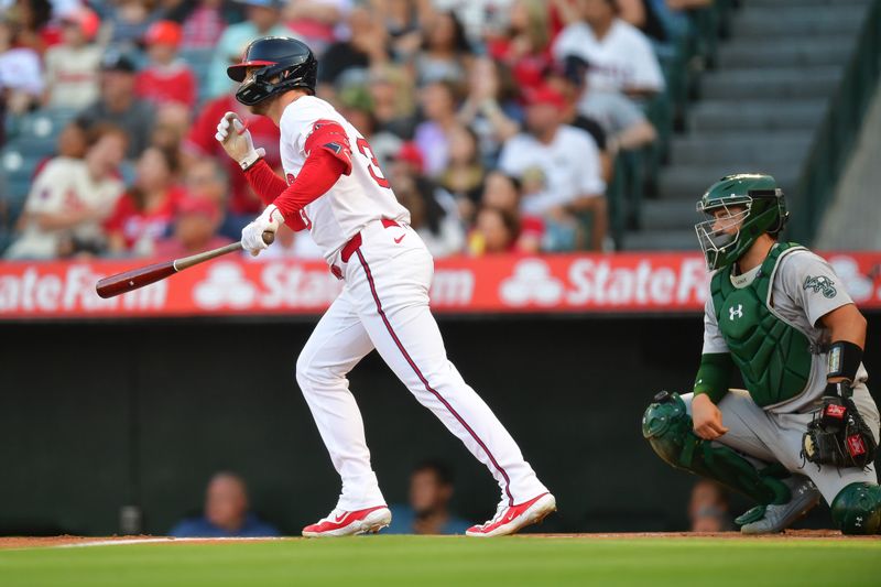 Jul 26, 2024; Anaheim, California, USA; Los Angeles Angels left fielder Taylor Ward (3) hits a two run home run against the Oakland Athletics during the first inning at Angel Stadium. Mandatory Credit: Gary A. Vasquez-USA TODAY Sports