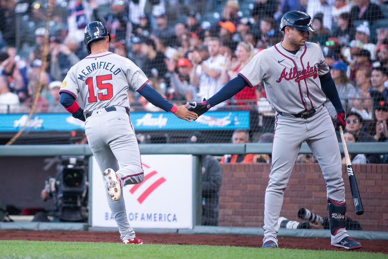 Aug 13, 2024; San Francisco, California, USA;  Atlanta Braves outfielder Whit Merrifield (15) celebrates with first base Matt Olson (28) after scoring against the San Francisco Giants during the second inning at Oracle Park. Mandatory Credit: Ed Szczepanski-USA TODAY Sports