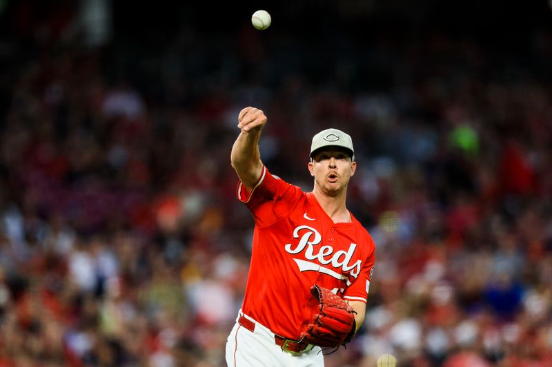 May 17, 2025; Cincinnati, Ohio, USA; Cincinnati Reds relief pitcher Emilio Pagan (15) throws to first to get Cleveland Guardians designated hitter Carlos Santana (not pictured) out in the ninth inning at Great American Ball Park. Mandatory Credit: Katie Stratman-Imagn Images