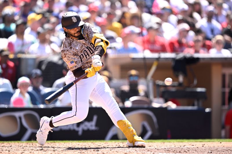 Apr 28, 2024; San Diego, California, USA; San Diego Padres catcher Luis Campusano (12) hits a three-run home run against the Philadelphia Phillies during the seventh inning at Petco Park. Mandatory Credit: Orlando Ramirez-USA TODAY Sports