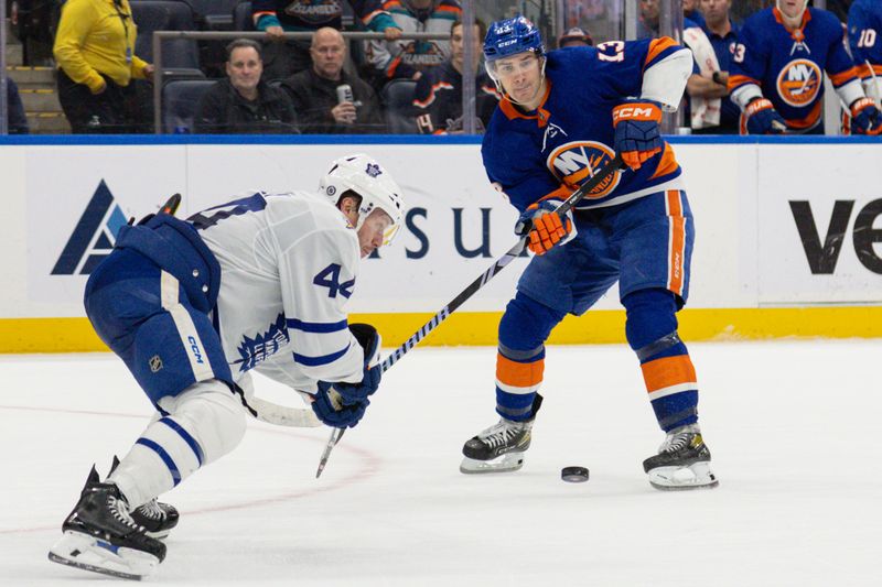 Dec 11, 2023; Elmont, New York, USA; New York Islanders center Mathew Barzal (13) makes a pass against the Toronto Maple Leafs that sets up the winning goal during the overtime period at UBS Arena. Mandatory Credit: Thomas Salus-USA TODAY Sports