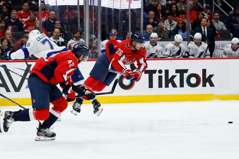 Oct 14, 2025; Washington, District of Columbia, USA; Washington Capitals center Nic Dowd (26) us tripped by Tampa Bay Lightning defenseman Emil Lilleberg (78) in the second period at Capital One Arena. Mandatory Credit: Geoff Burke-Imagn Images