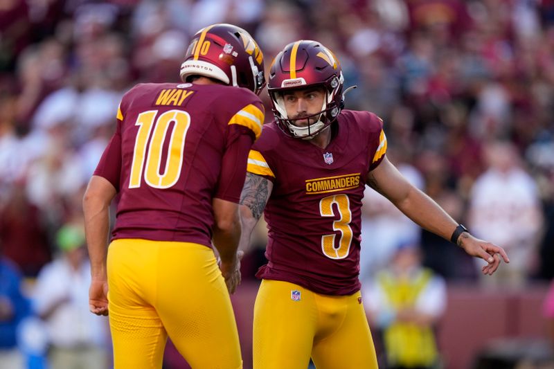 Washington Commanders place kicker Austin Seibert (3) celebrates with teammate Tress Way (10) after kicking a 23-yard field goal during the first half of an NFL football game against the Carolina Panthers, Sunday, Oct. 20, 2024, in Landover, Md. (AP Photo/Stephanie Scarbrough)