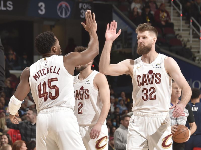 CLEVELAND, OH - DECEMBER 13: Donovan Mitchell #45 and Dean Wade #32 of the Cleveland Cavaliers high five during the game against the Washington Wizards on December 13, 2024 at Rocket Mortgage FieldHouse in Cleveland, Ohio. NOTE TO USER: User expressly acknowledges and agrees that, by downloading and/or using this Photograph, user is consenting to the terms and conditions of the Getty Images License Agreement. Mandatory Copyright Notice: Copyright 2024 NBAE (Photo by David Liam Kyle/NBAE via Getty Images)