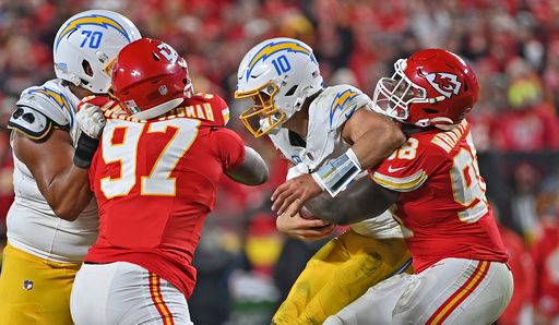 Kansas City Chiefs defensive tackle Tershawn Wharton (98) sacks Los Angeles Chargers quarterback Justin Herbert (10) during an NFL football game Sunday, Dec. 8, 2024, in Kansas City, Mo. (AP Photo/Peter Aiken)