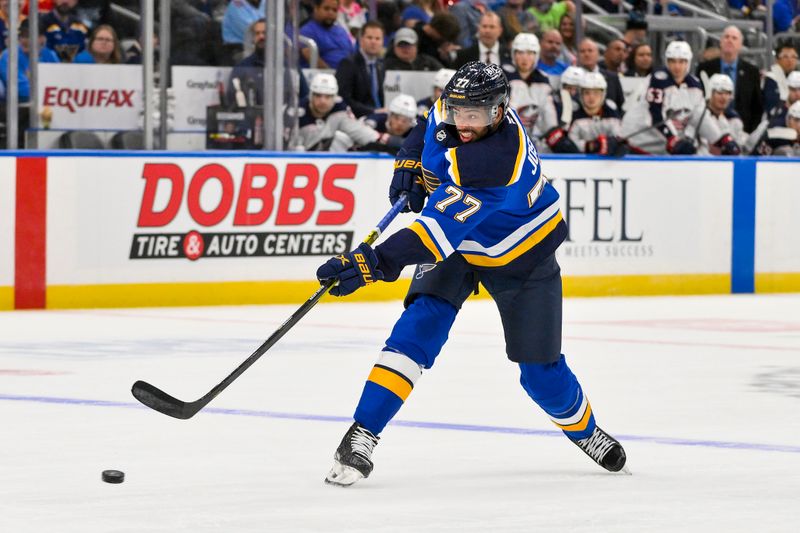 Oct 1, 2024; St. Louis, Missouri, USA;  St. Louis Blues defenseman Pierre-Olivier Joseph (77) shoots against the Columbus Blue Jackets during the second period at Enterprise Center. Mandatory Credit: Jeff Curry-Imagn Images