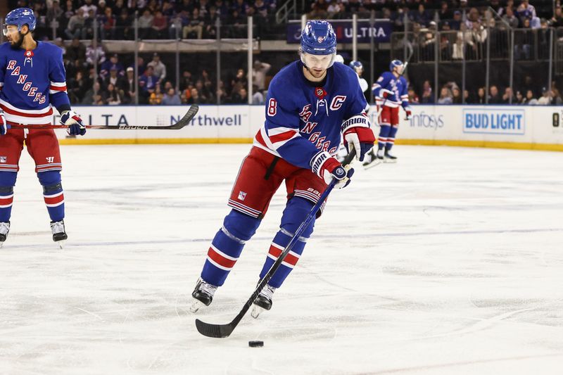 Apr 7, 2024; New York, New York, USA;  New York Rangers defenseman Jacob Trouba (8) controls the puck in the first period against the Montreal Canadiens at Madison Square Garden. Mandatory Credit: Wendell Cruz-USA TODAY Sports