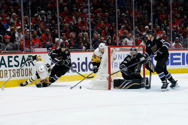 Jan 18, 2025; Washington, District of Columbia, USA; Pittsburgh Penguins center Blake Lizotte (46), Washington Capitals defenseman Rasmus Sandin (38) and Penguins center Noel Acciari (55) battle for the puck behind Capitals goaltender Logan Thompson (48) in the second period at Capital One Arena. Mandatory Credit: Geoff Burke-Imagn Images