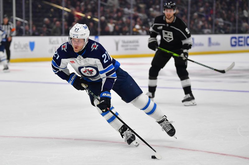 Dec 13, 2023; Los Angeles, California, USA; Winnipeg Jets left wing Nikolaj Ehlers (27) moves the puck against the Los Angeles Kings during the first period at Crypto.com Arena. Mandatory Credit: Gary A. Vasquez-USA TODAY Sports